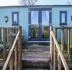 Entrance with steps and seating area at Shepherds Delight in Biddulph Moor