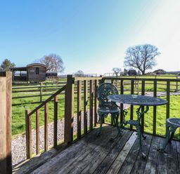 An outdoor area with a table and chairs at Shepherds Delight in Biddulph Moor