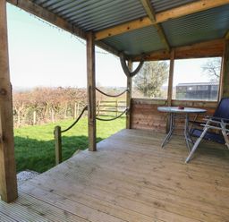 An outdoor patio with a table and chairs at Golden Fleece in Biddulph Moor