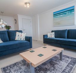 A living room with sofas and a coffee table at 21 Compass Point in Carbis Bay