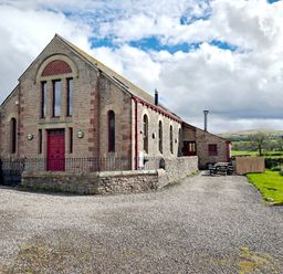 A building with parking area and outdoor seating at Kaber Chapel in Kaber near Kirby Stephen