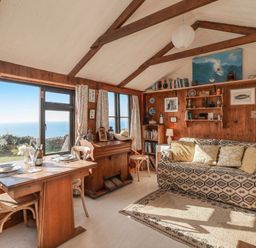 A living room with a dining table and sofa at The Cabin