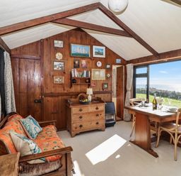 A living room with a table and chairs at The Cabin in 
