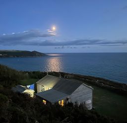 A house by the ocean with a view of the moon at The Cabin 