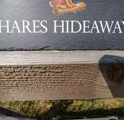 A sign with Hares Hideaway at Hares Hideaway Shepherd's Hut South Molton