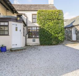 An outdoor area with a door and windows at The Farmhouse in Keswick