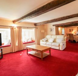 A living room with a sofa and coffee table at The Farmhouse in Keswick