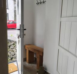 An entrance hall with a bench and coat hooks at Bobbin Nook in Staveley