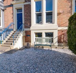 An outdoor area with steps, bench, and gravel at The Hideaway in Whitby