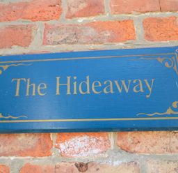 A sign that says The Hideaway on a brick wall at The Hideaway in Whitby
