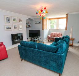 A living room with a sofa and television at The Hideaway in Whitby