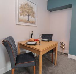 A dining room with a table and chairs at Cuckoo's Nest in Whitby