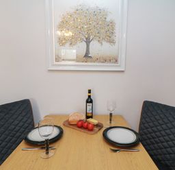 A dining room with a table set for two at Cuckoo's Nest in Whitby