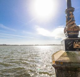 A lamp post beside water with buildings in the background at Flat 17 Golden Gates in Poole