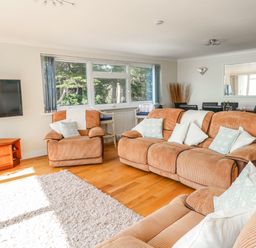 A living room with sofa and television at Flat 17 Golden Gates in Poole
