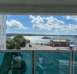 A view of the sea with a boat and construction site at Flat 17 Golden Gates Sandbanks
