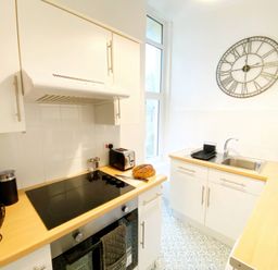 A kitchen with cabinets and a sink at 2A Redcliffe in Torquay