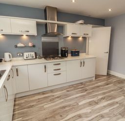 A kitchen with appliances and cabinets at Sugar Loft in Silloth