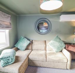 A snug with a sofa and plant at The Nest Lodge 55 Grantham