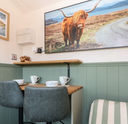 A dining room with a table and mugs at Salt Haven Shepards Hut Pevensey