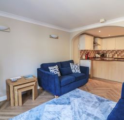 A living room with a sofa and television at 6 Dartmouth House in Dartmouth