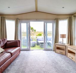 A living room with a sofa and table at Pemberton Knightsbridge in Morfa Bychan