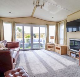 A living room with sofas and a television at Pemberton Knightsbridge in Morfa Bychan