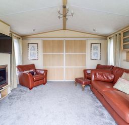 A living room with a television and fireplace at Pemberton Knightsbridge in Morfa Bychan