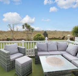 An outdoor patio with seating and a view at Pemberton Knightsbridge Morfa Bychan