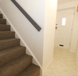 A hallway with stairs and a door at Amber House in Dorchester