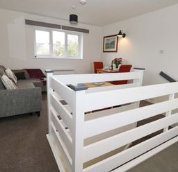 A living room with a sofa and dining area at Amber House in Dorchester
