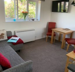 A living room with a sofa and table at Amber House in Dorchester