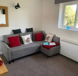 A living room with a sofa and window at Amber House Dorchester