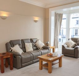 A living room with a sofa and armchairs at Time Out in Whitby