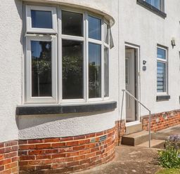 An outdoor area with windows and a front door at The Arches in Torquay
