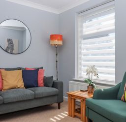 A living room with a sofa and coffee table at The Arches in Torquay