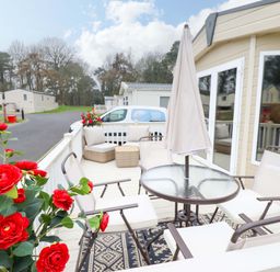 An outdoor patio with a table and chairs at 108 Fox Burrow Hang in Great Yarmouth