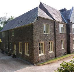 A house with multiple windows and a driveway at Lukesland Wing near Ivybridge