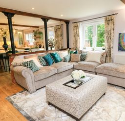 A living room with a sofa and coffee table at The Coach House near Charminster