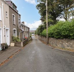 A street view with houses along a road at Ty Pen in Nefyn