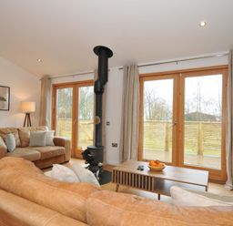 A living room with a fireplace and coffee table at 4 Southern Place in Dobwalls