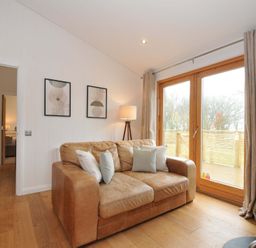 A living room with a sofa and lamp at 4 Southern Place in Dobwalls