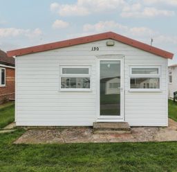 A cabin with a door and windows at 130 Park Ave Holiday Village