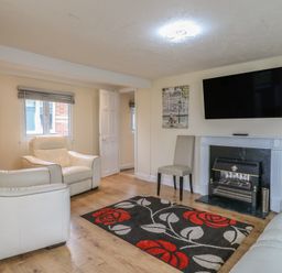 A living room with a television and fireplace at 130 Park Ave Holiday Village