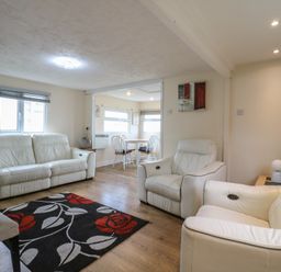A living room with two sofas and a dining area at 130 Park Ave Holiday Village