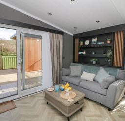 A snug with a sofa and a coffee table at Dawn's Rest Nantmel near Rhayader