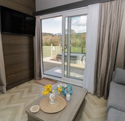 A living room with a sofa and table at Dawn's Rest in Nantmel near Rhayader