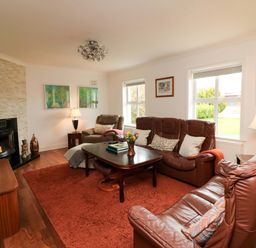 A living room with sofas and a coffee table at Sunnyside River Chapel