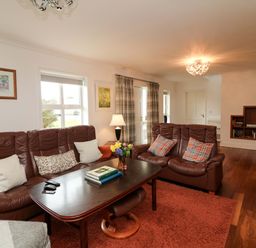 A living room with a sofa and coffee table at Sunnyside in River Chapel