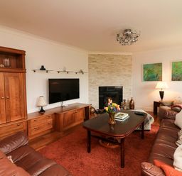 A living room with a television and sofa at Sunnyside in River Chapel